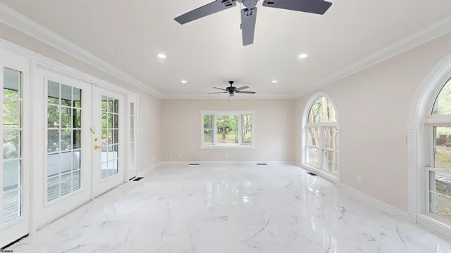 a view of an empty room with stairs and a window
