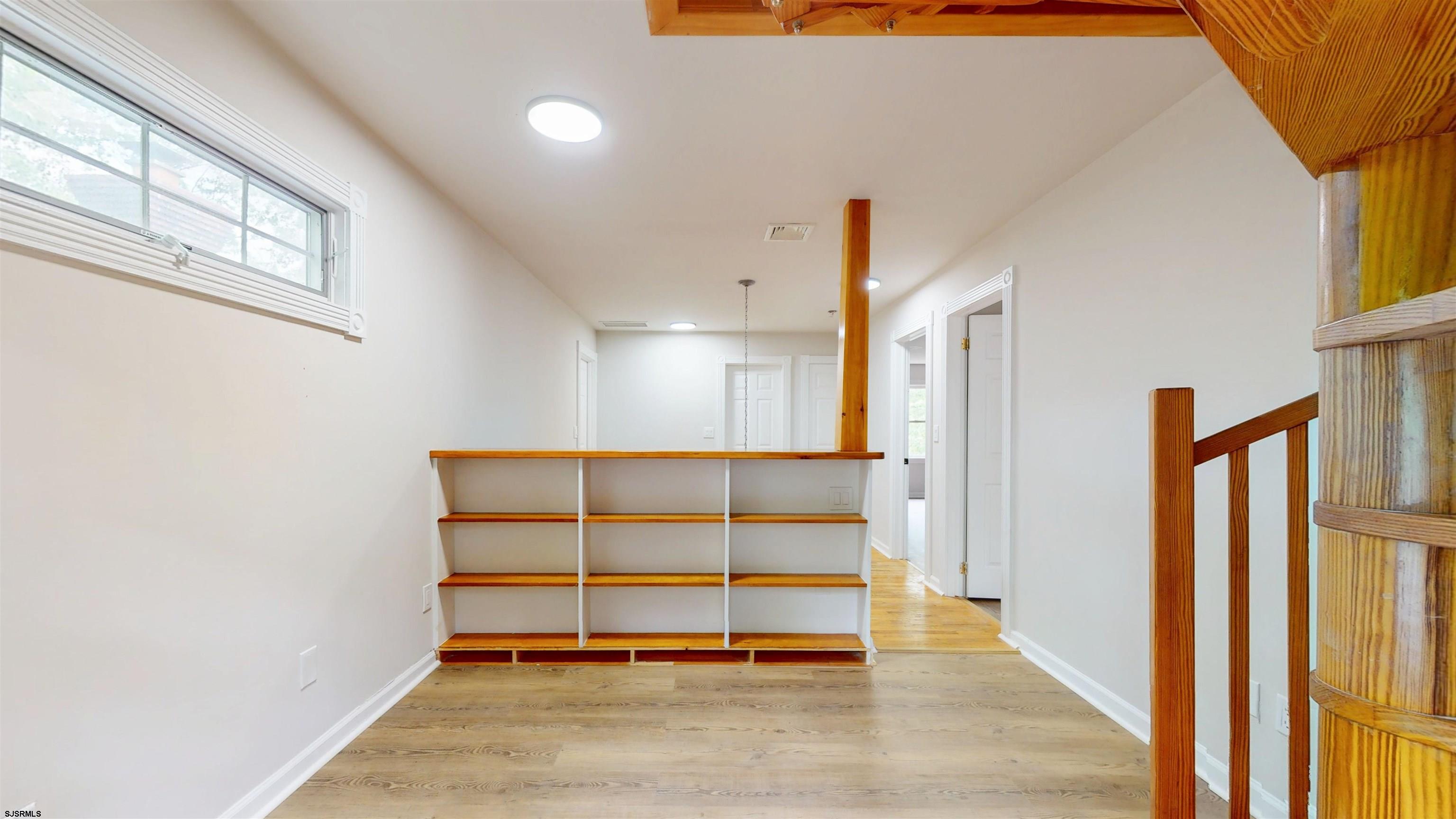 254 West Cologne Port Republic Road Egg Harbor City, NJ 08215 - Photo 36 of 81 a view of an empty room with wooden floor and a window