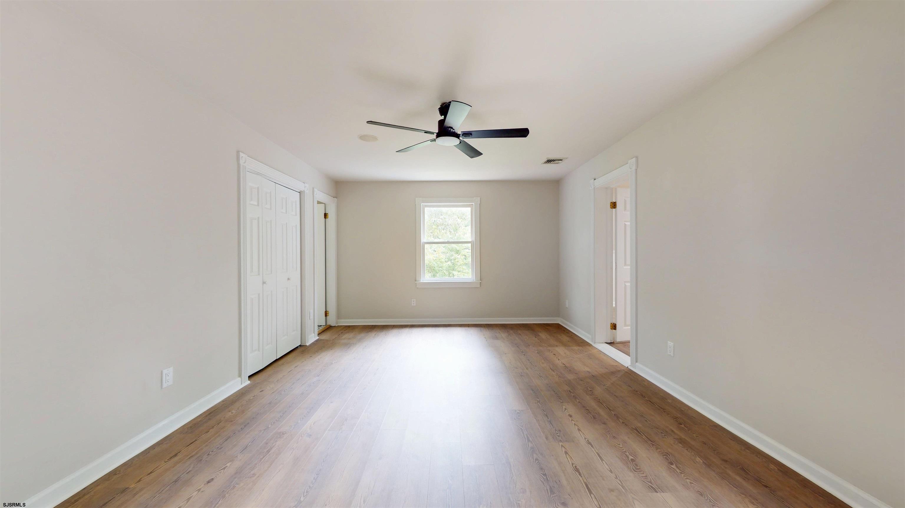 254 West Cologne Port Republic Road Egg Harbor City, NJ 08215 - Photo 40 of 81 wooden floor in an empty room with a window