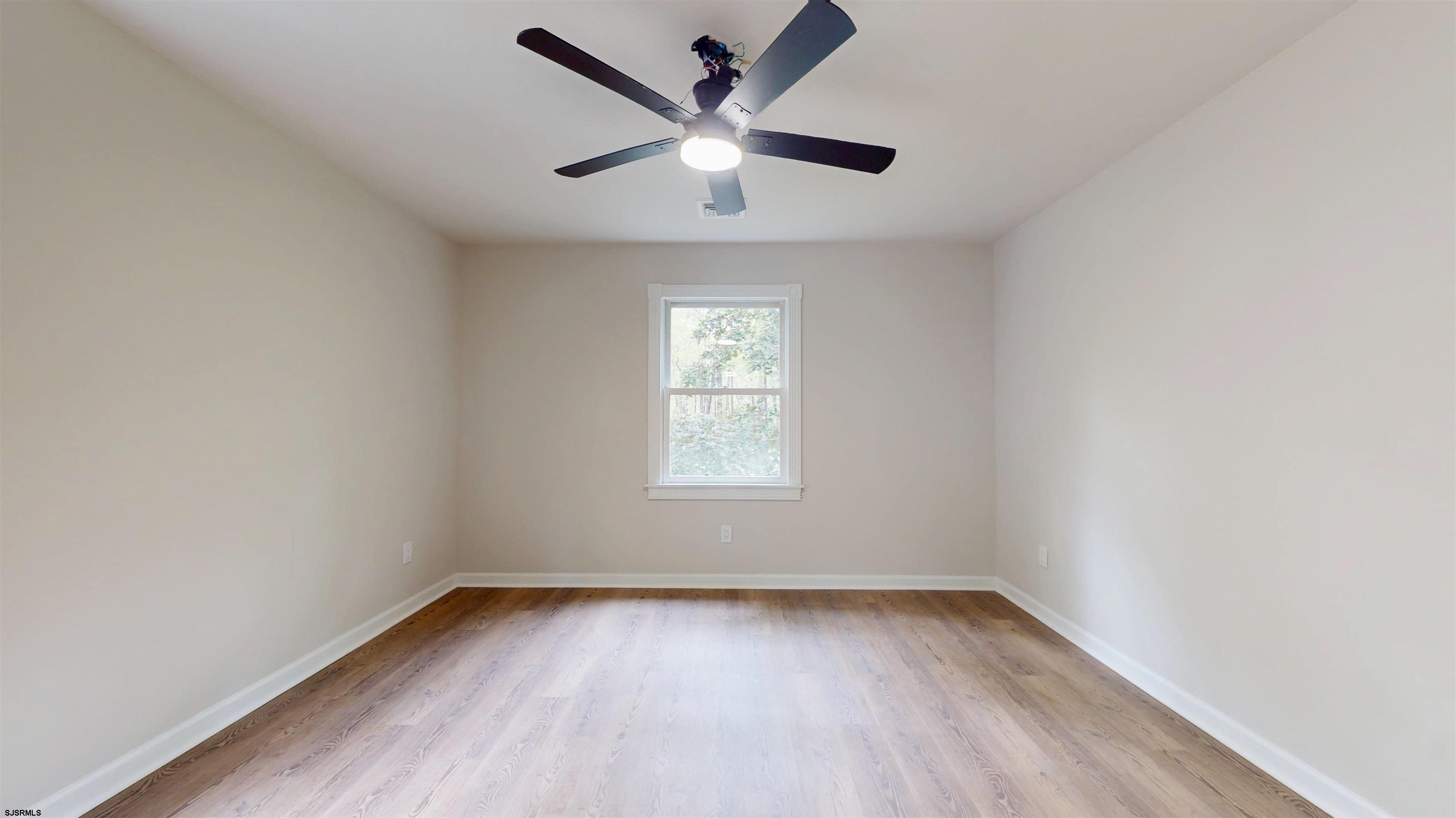 254 West Cologne Port Republic Road Egg Harbor City, NJ 08215 - Photo 46 of 81 an empty room with wooden floor and windows