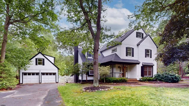 a front view of a residential houses with yard and green space