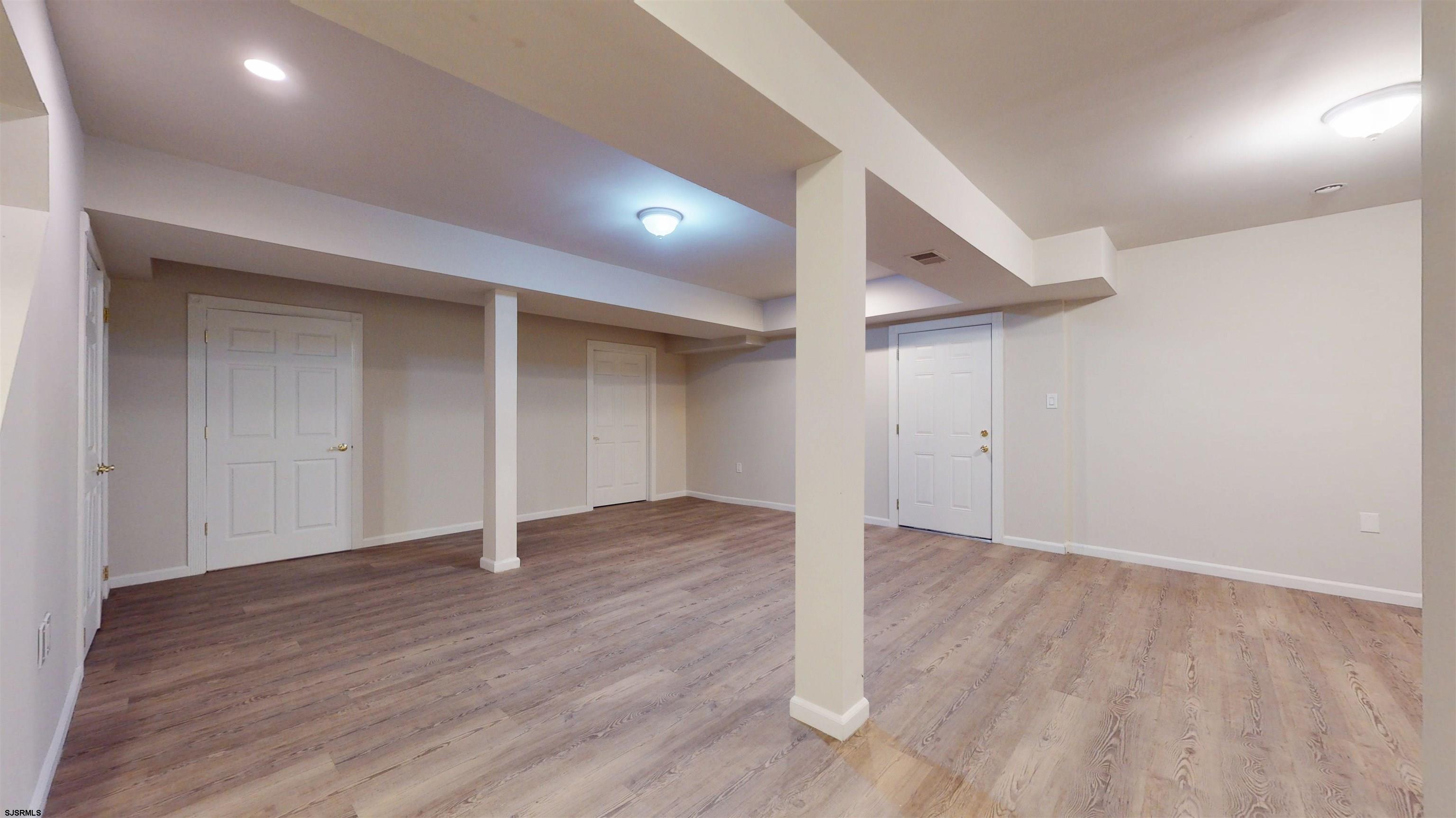 254 West Cologne Port Republic Road Egg Harbor City, NJ 08215 - Photo 56 of 81 an empty room with wooden floor & windows