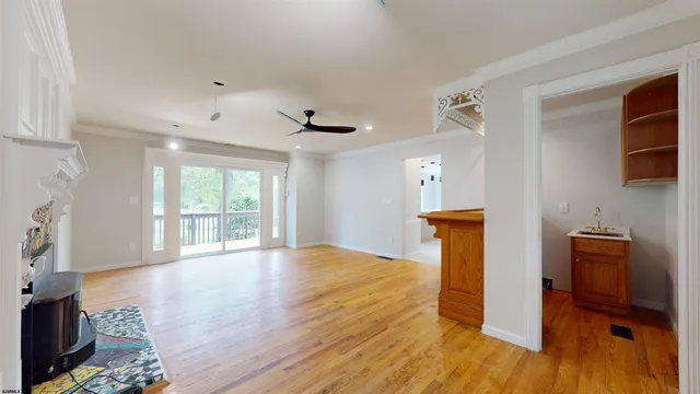 a large kitchen with kitchen island a large counter and stainless steel appliances