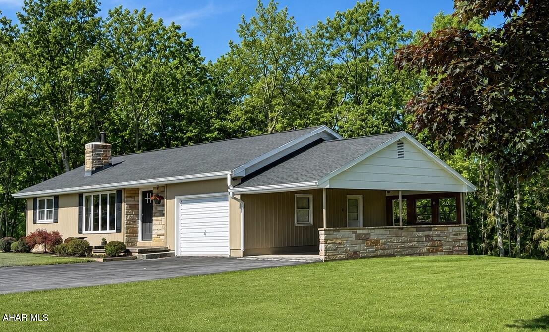 473 Calhoun Road Everett, PA 15537 - Photo 2 of 45 a front view of a house with a yard and porch