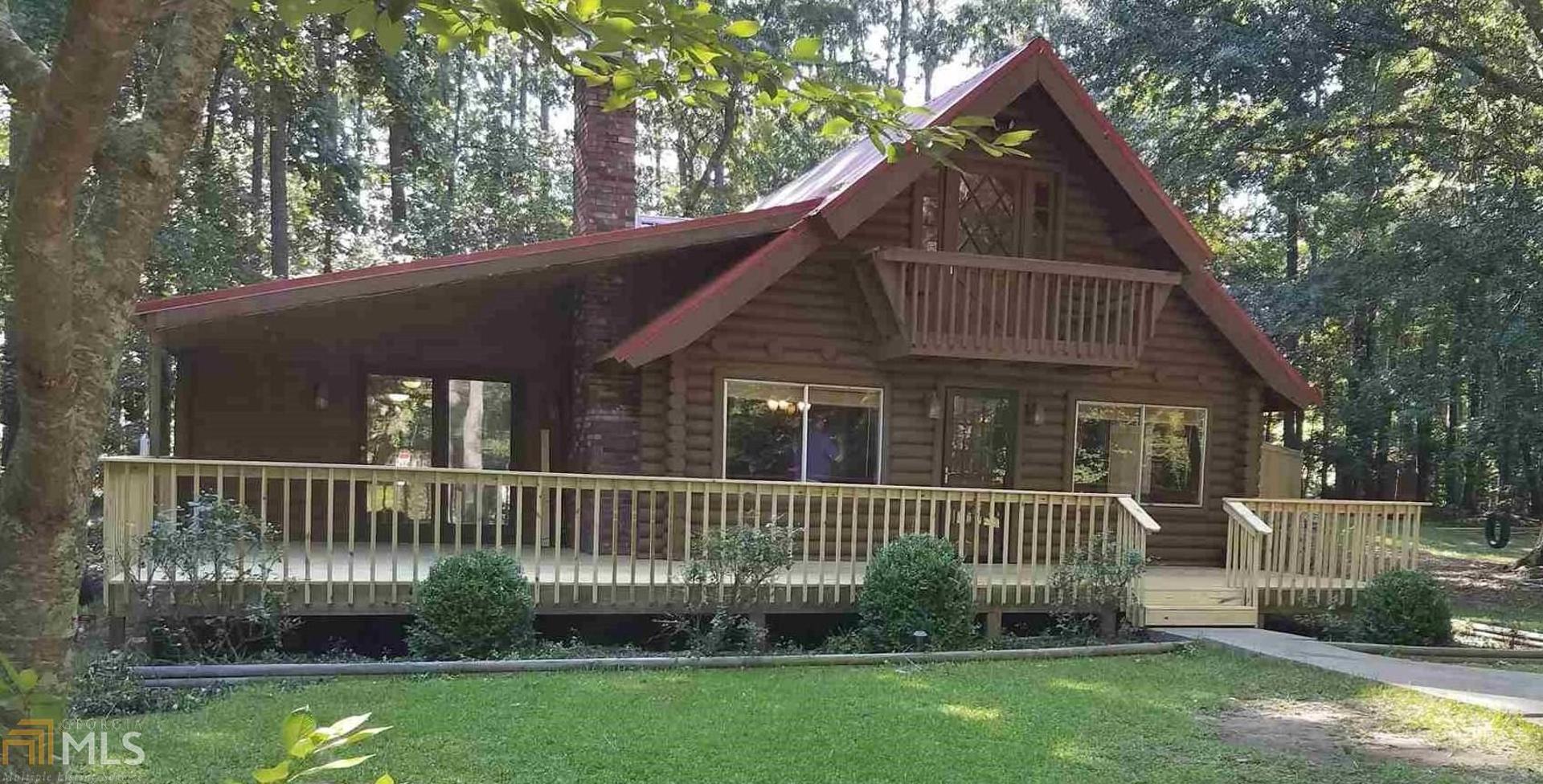 81 Whippoorwill Road Monticello, GA 31064 - Photo 1 of 1 a front view of a house with a garden