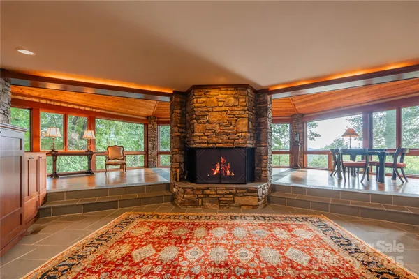 a view of empty room with wooden floor and fireplace
