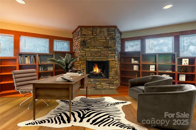 a living room with furniture a fireplace and a large window