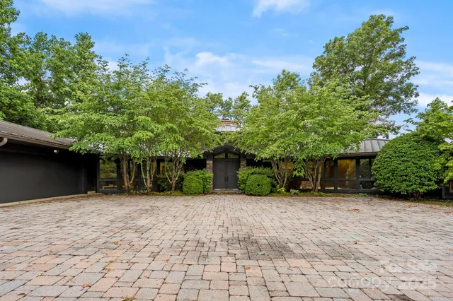 a view of a house with a yard and tree