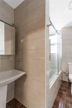 a bathroom with a bathtub and toilet