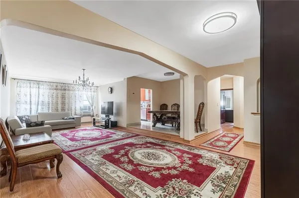 a living room with a rug and a table
