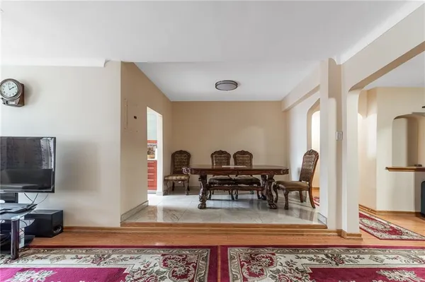 a living room with furniture a rug and a flat screen tv