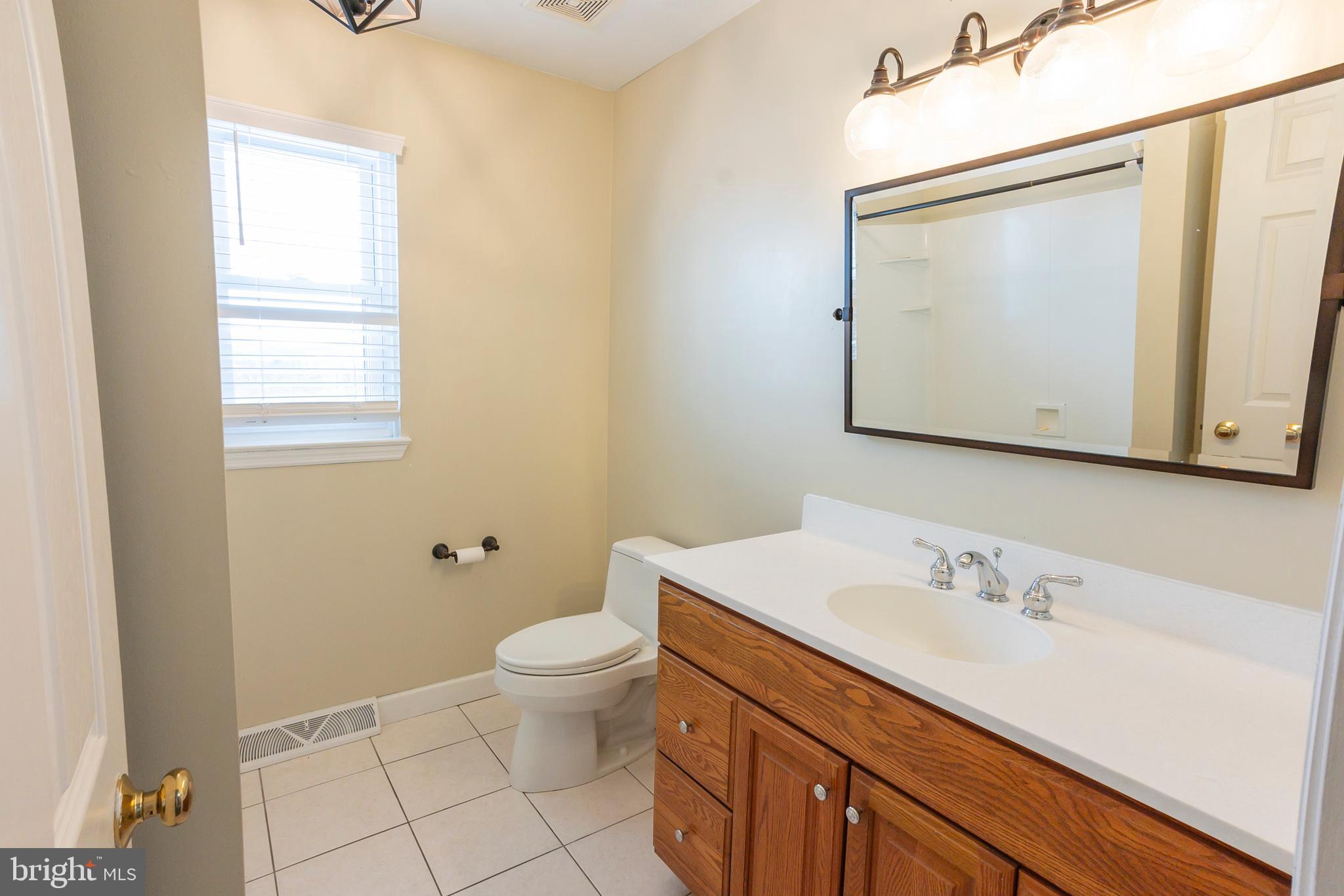 6 Overview Court Reading, PA 19607 - Photo 42 of 69 a bathroom with a granite countertop sink a mirror and a toilet