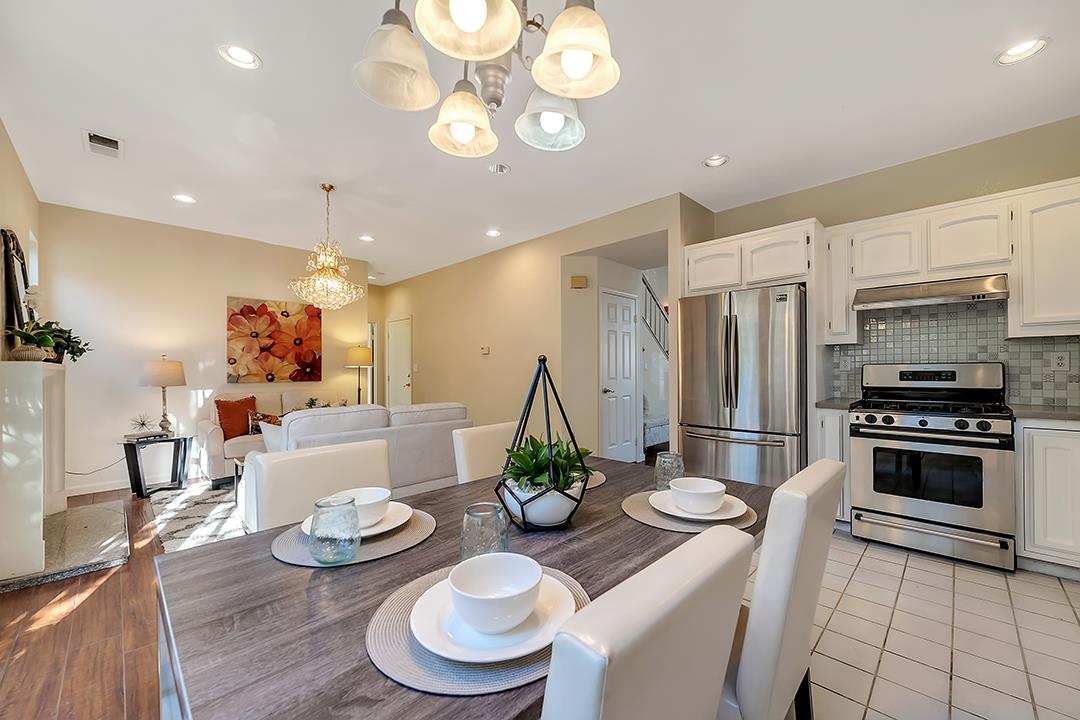 239 Balboa Drive Milpitas, CA 95035 - Photo 14 of 57 a kitchen with stainless steel appliances a table and chairs in it