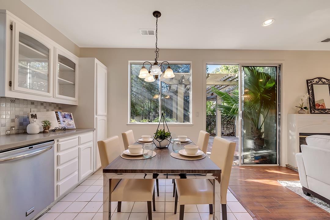 239 Balboa Drive Milpitas, CA 95035 - Photo 16 of 57 a kitchen with stainless steel appliances a table and chairs in it