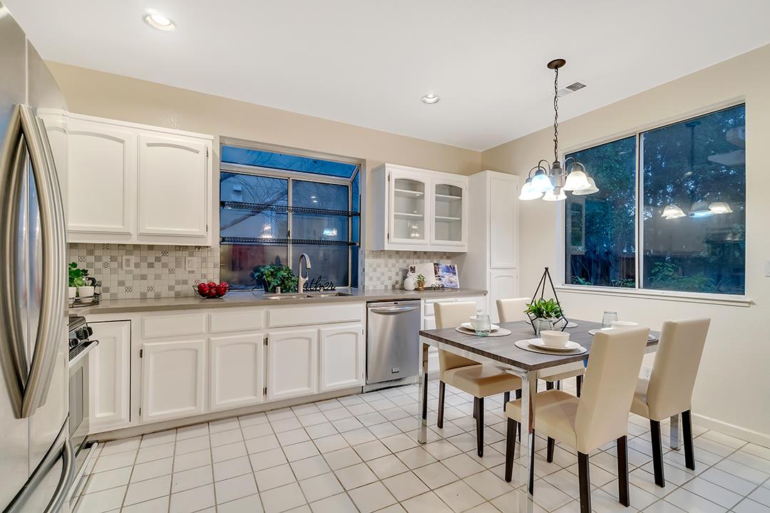 239 Balboa Drive Milpitas, CA 95035 - Photo 19 of 57 a kitchen with a dining table chairs sink and cabinets