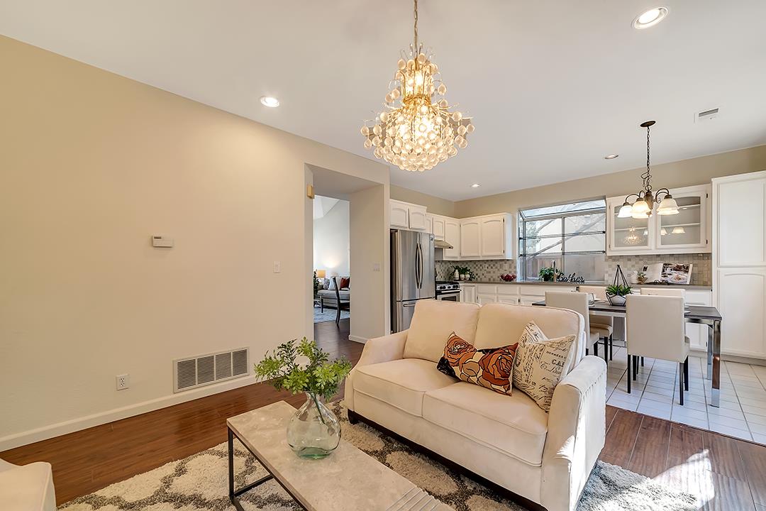 239 Balboa Drive Milpitas, CA 95035 - Photo 21 of 57 a living room with furniture and a chandelier