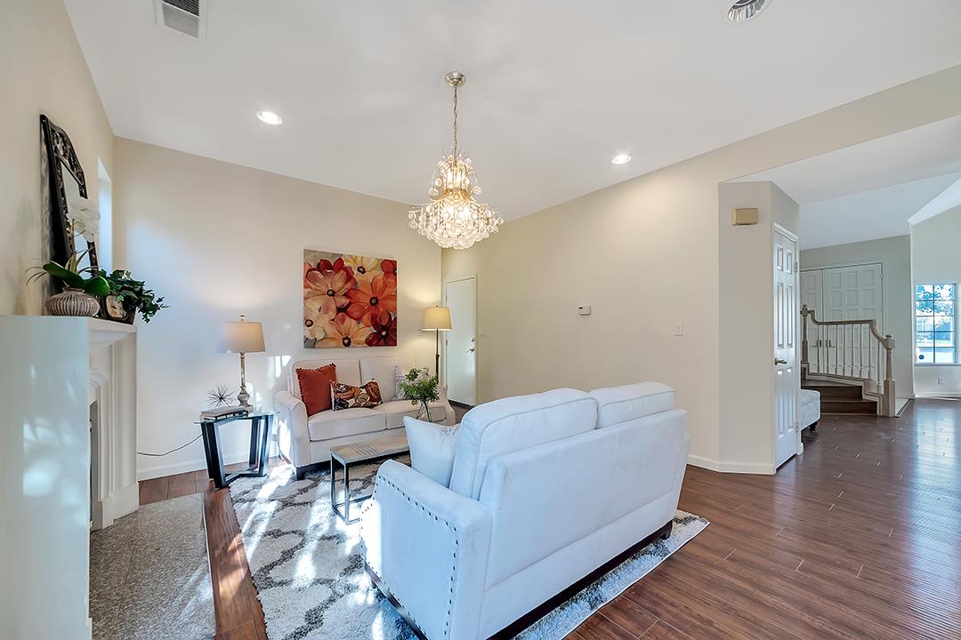 239 Balboa Drive Milpitas, CA 95035 - Photo 22 of 57 a living room with furniture and a chandelier
