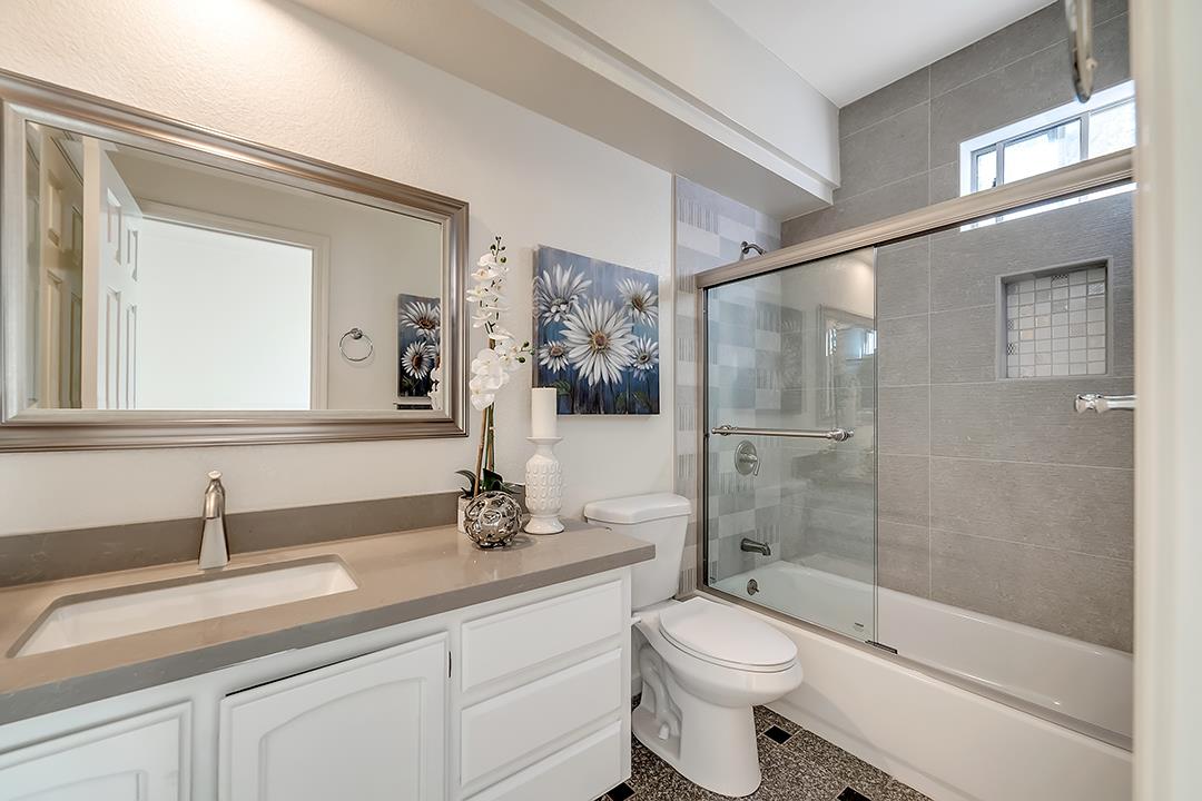 239 Balboa Drive Milpitas, CA 95035 - Photo 35 of 57 a bathroom with a granite countertop toilet sink shower and mirror