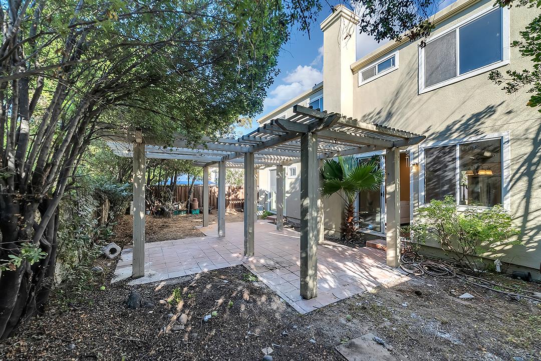239 Balboa Drive Milpitas, CA 95035 - Photo 45 of 57 a view of a patio with table and chairs under an umbrella
