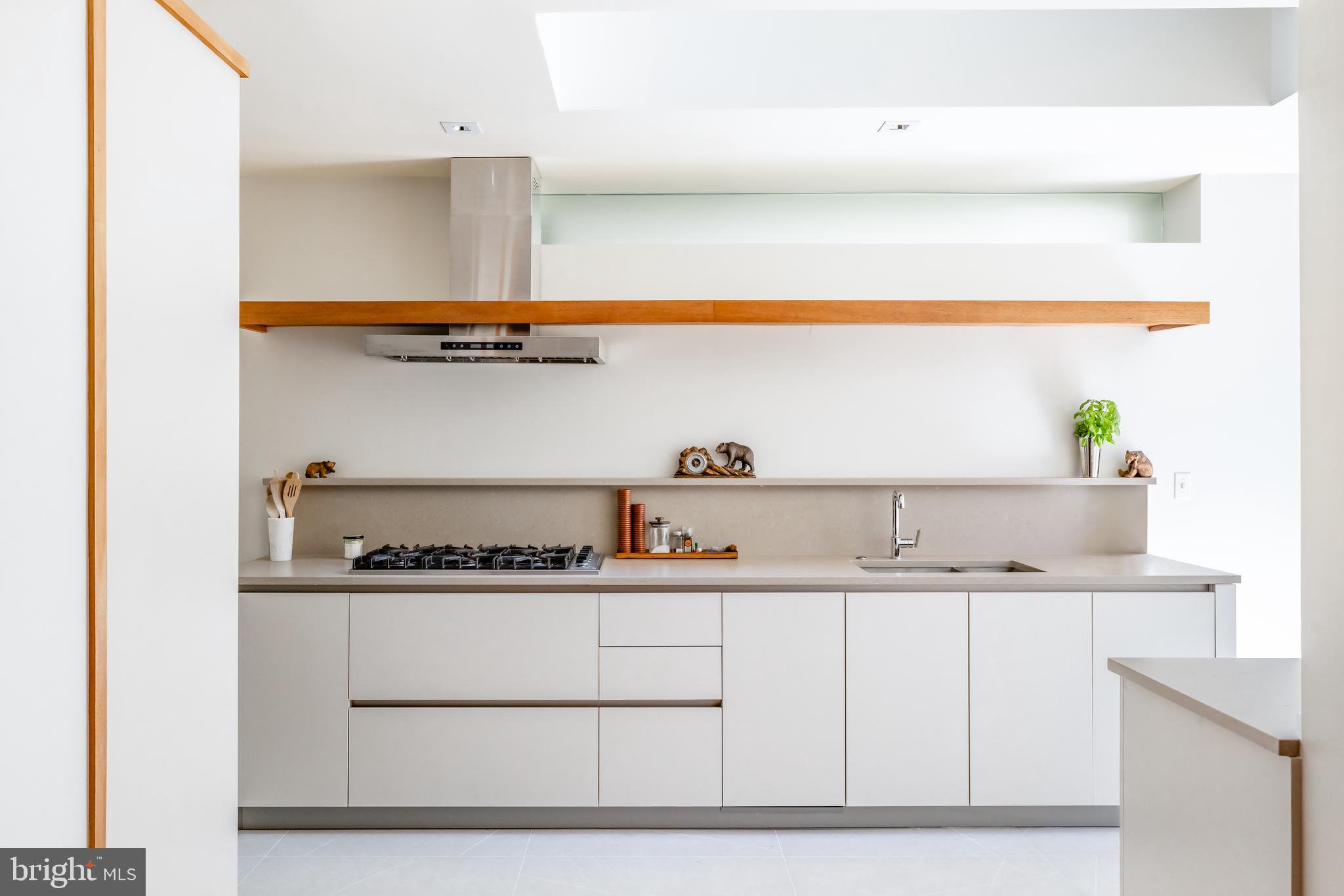 2740 Chain Bridge Road Northwest Washington, DC 20016 - Photo 13 of 50 a kitchen with stainless steel appliances granite countertop a sink and a stove