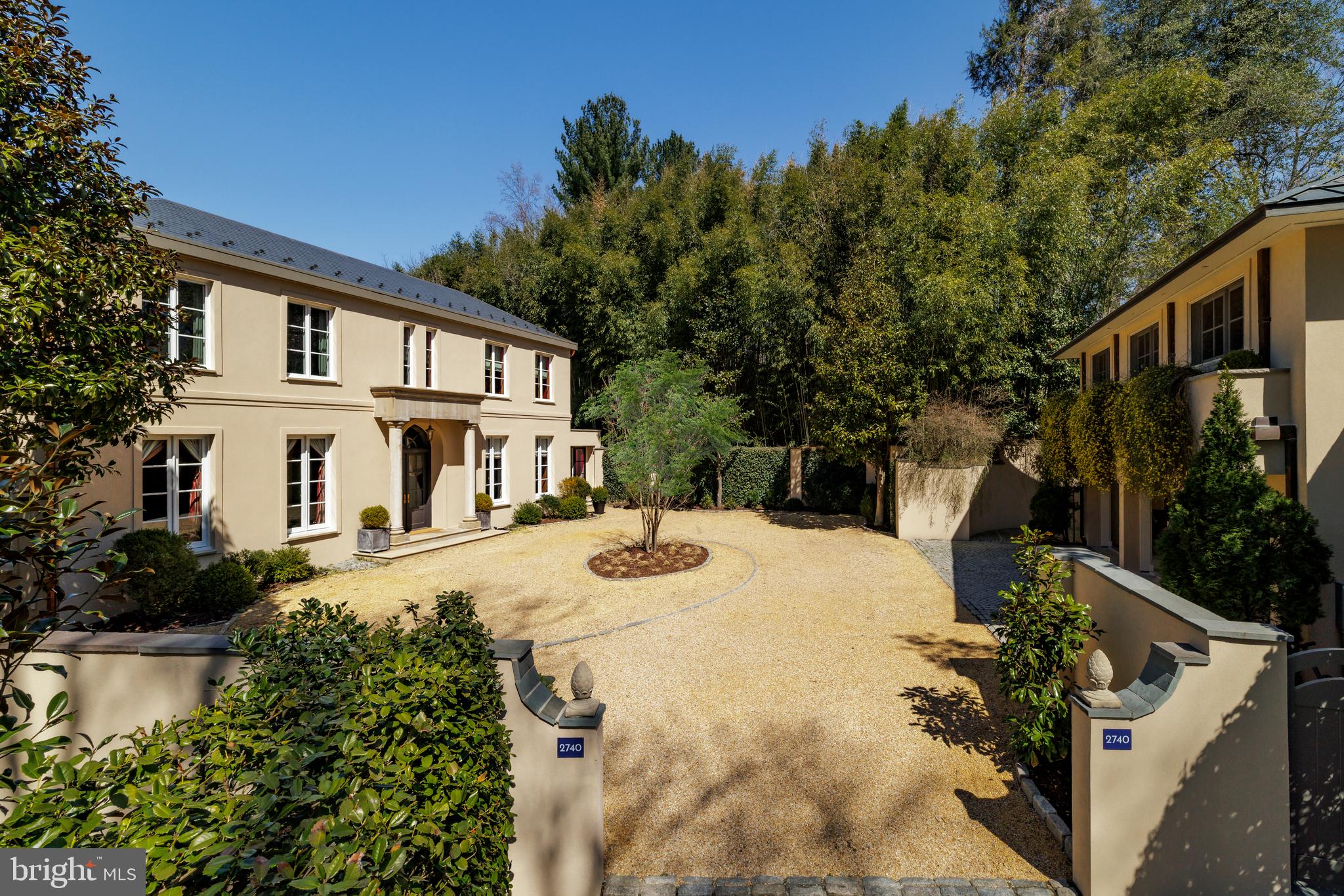 2740 Chain Bridge Road Northwest Washington, DC 20016 - Photo 2 of 50 a front view of a house with yard and green space