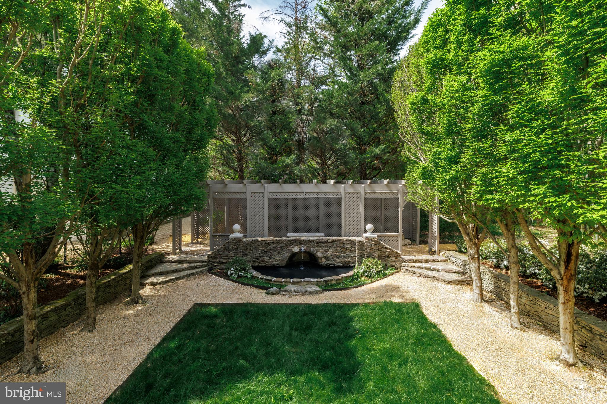 2740 Chain Bridge Road Northwest Washington, DC 20016 - Photo 22 of 50 a view of a backyard with table and chairs potted plants and large tree