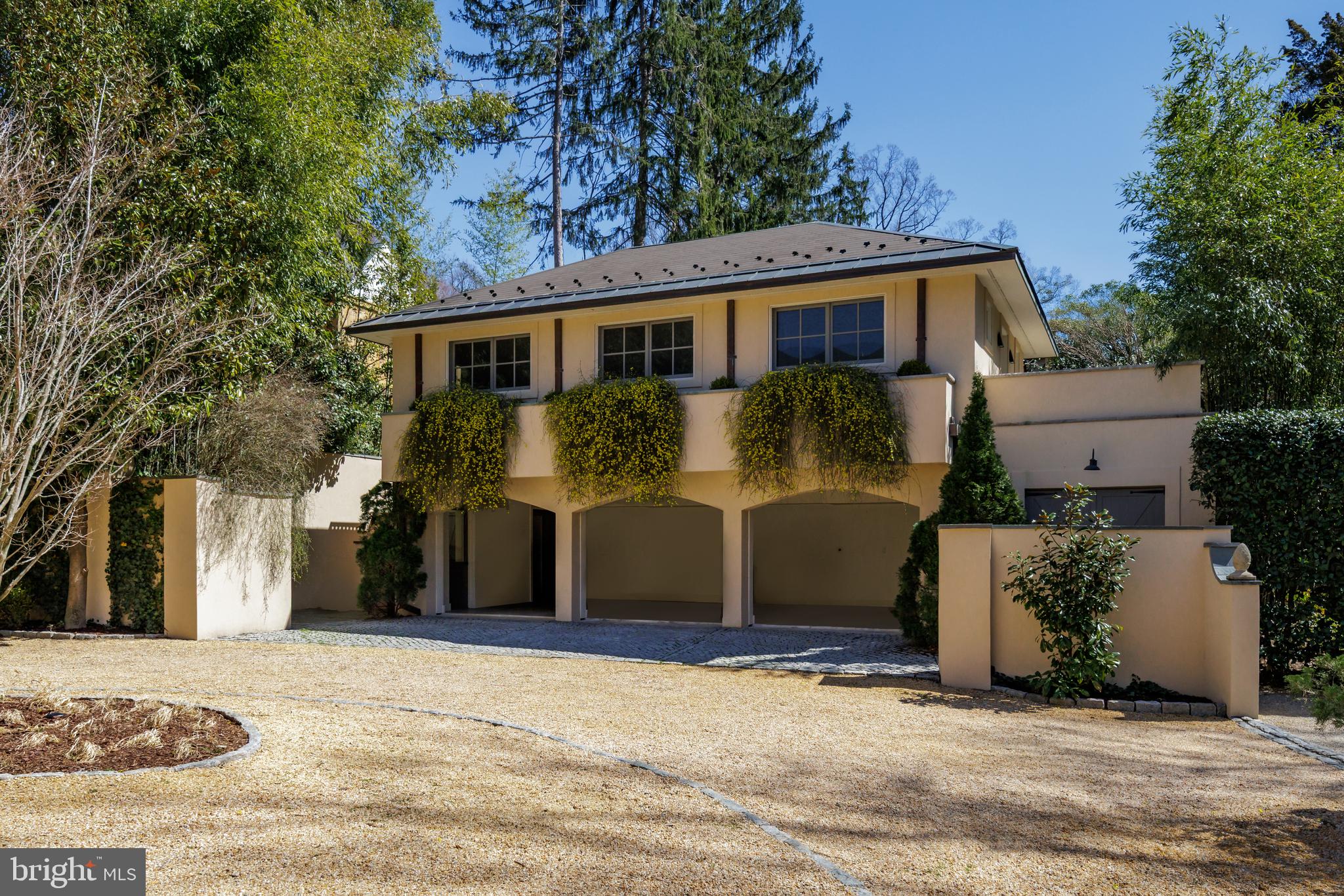 2740 Chain Bridge Road Northwest Washington, DC 20016 - Photo 3 of 50 a front view of a house with a yard and garage