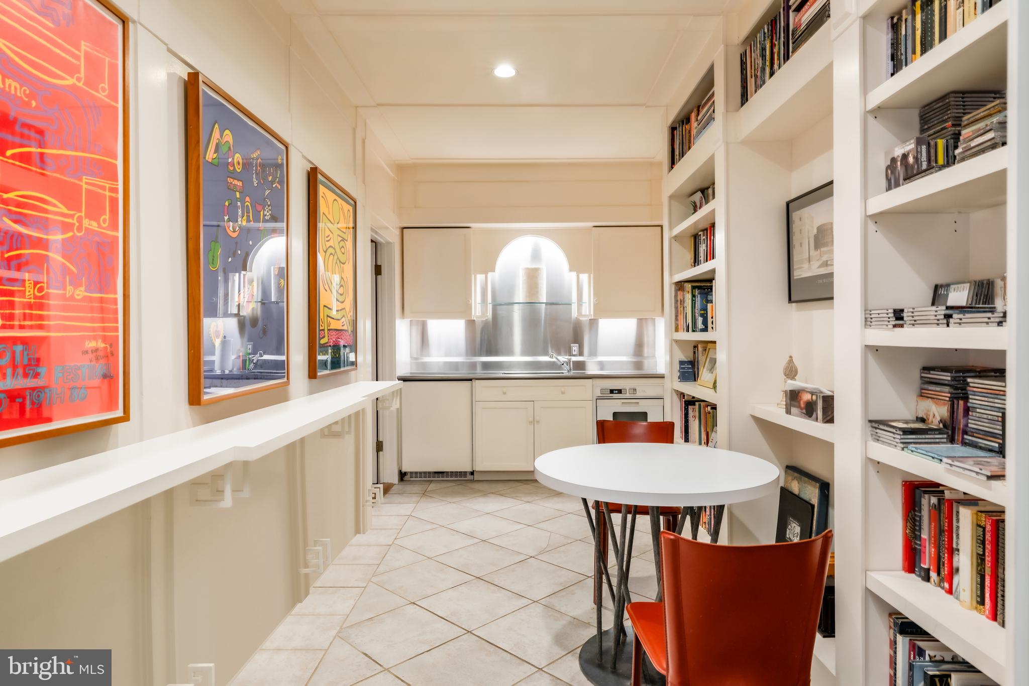 2740 Chain Bridge Road Northwest Washington, DC 20016 - Photo 37 of 50 a kitchen with stainless steel appliances a table chairs and a refrigerator