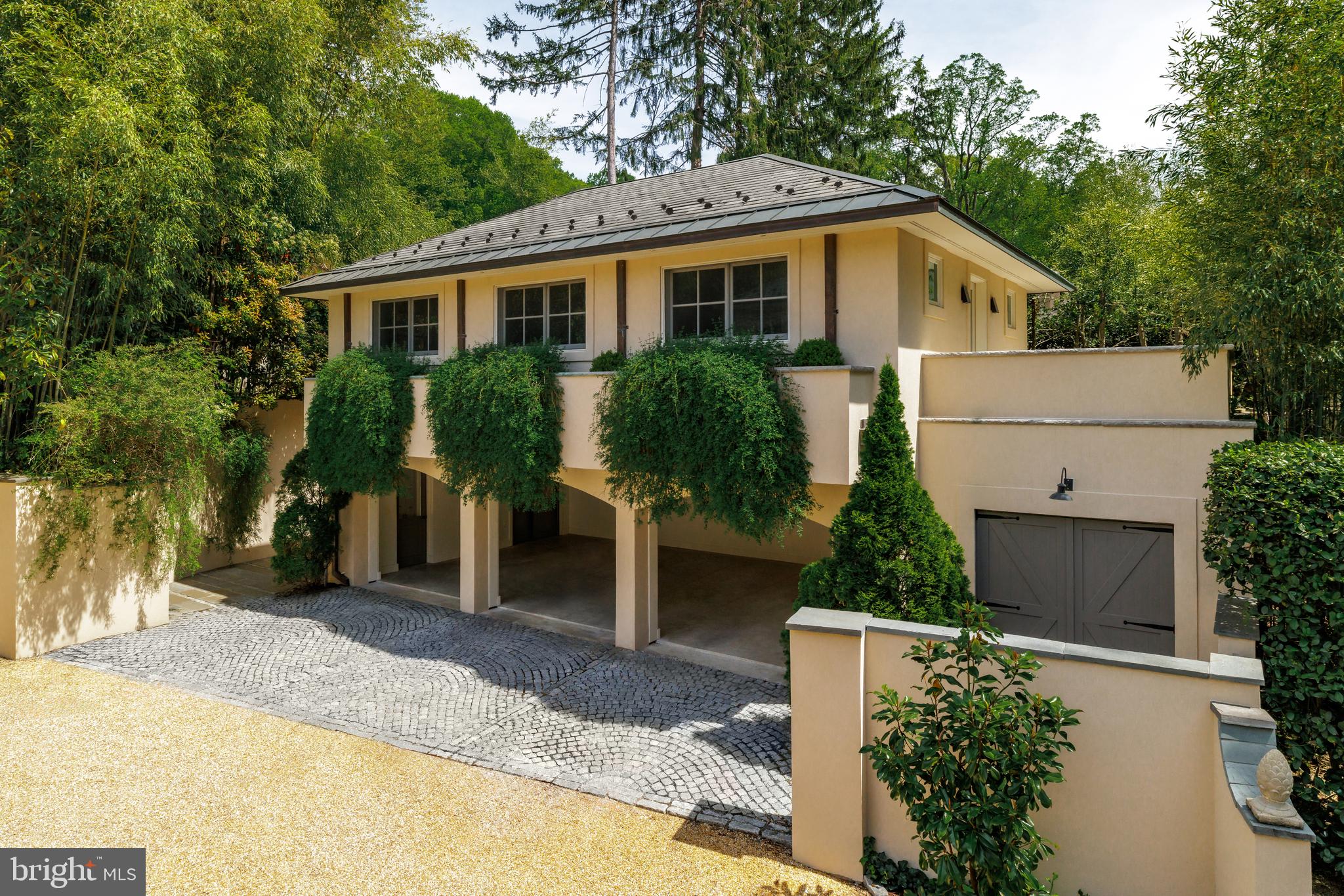 2740 Chain Bridge Road Northwest Washington, DC 20016 - Photo 39 of 50 a view of house with a yard and potted plants