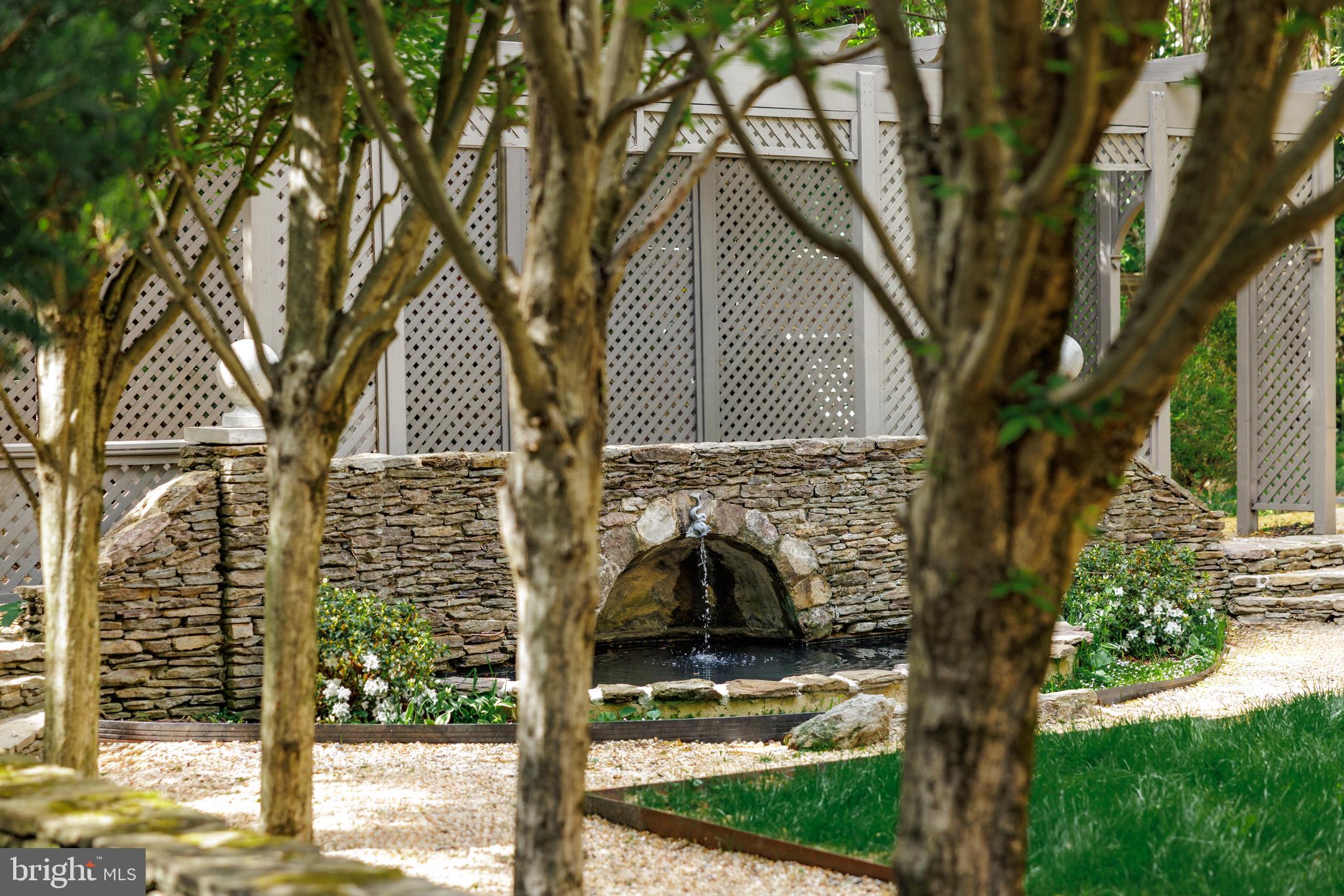 2740 Chain Bridge Road Northwest Washington, DC 20016 - Photo 44 of 50 a view of a house with a tree in front of it