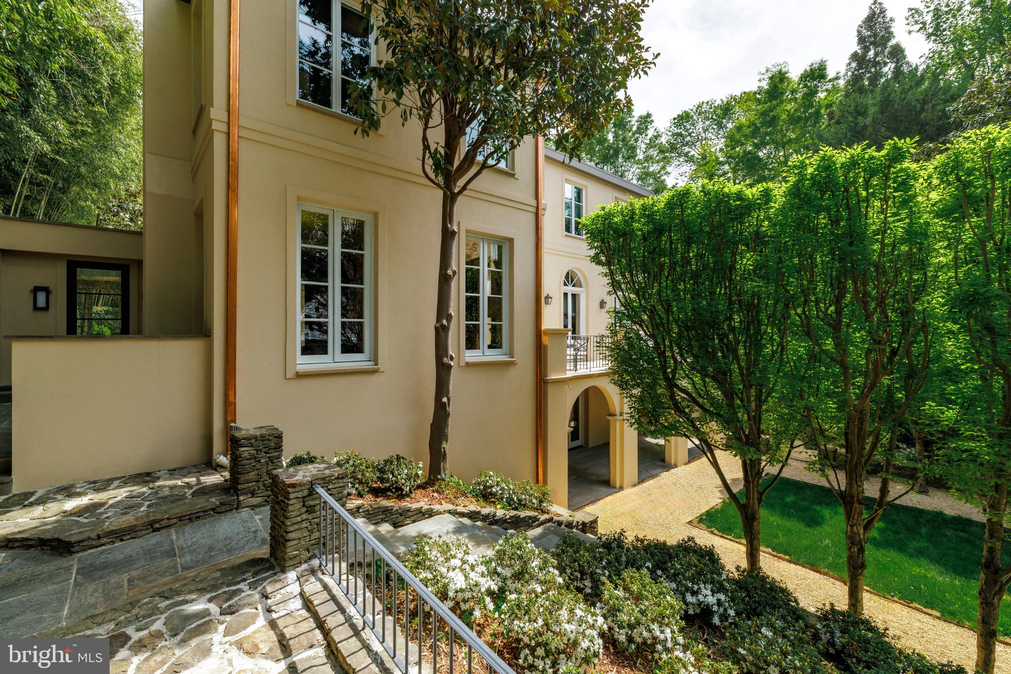 2740 Chain Bridge Road Northwest Washington, DC 20016 - Photo 46 of 50 a front view of a house with trees around