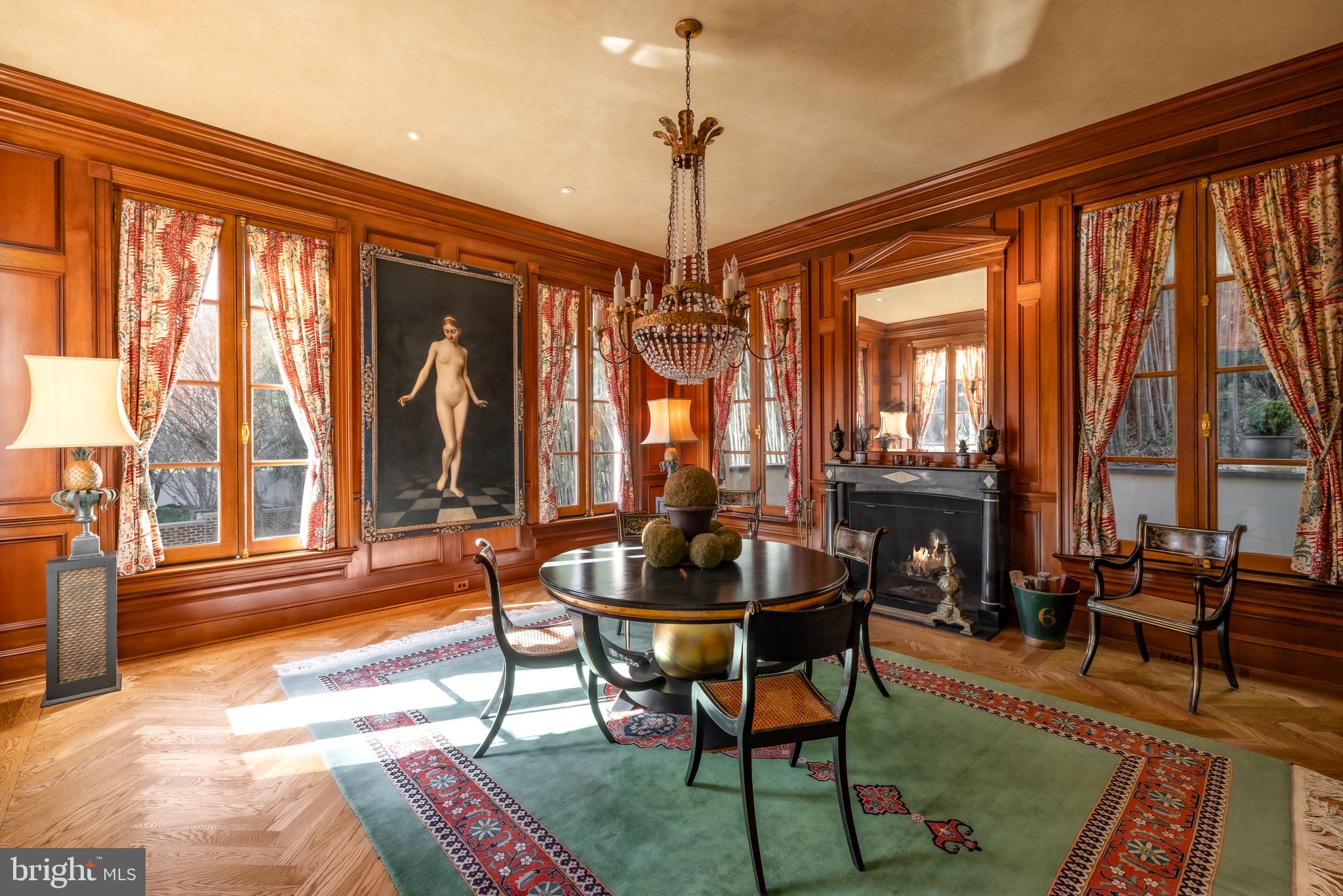 2740 Chain Bridge Road Northwest Washington, DC 20016 - Photo 9 of 50 a dining room with furniture large windows and a chandelier