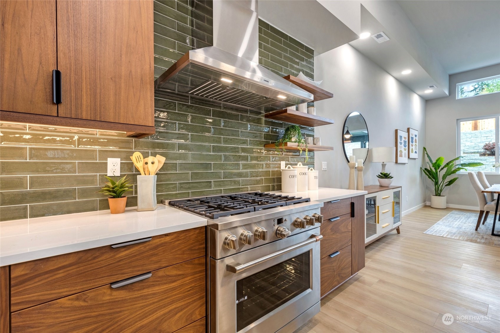 10053 Northeast 196th Place Bothell, WA 98011 - Photo 11 of 40 a kitchen with stainless steel appliances granite countertop a sink a stove and a wooden floors