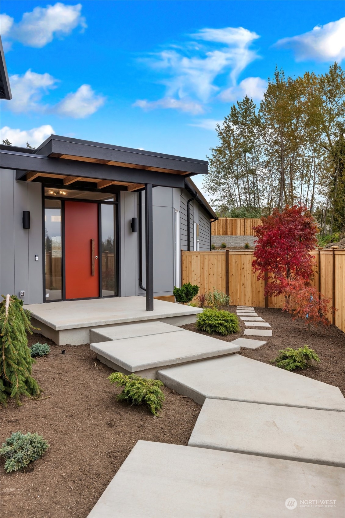 10053 Northeast 196th Place Bothell, WA 98011 - Photo 4 of 40 a front view of a house with garden and plants