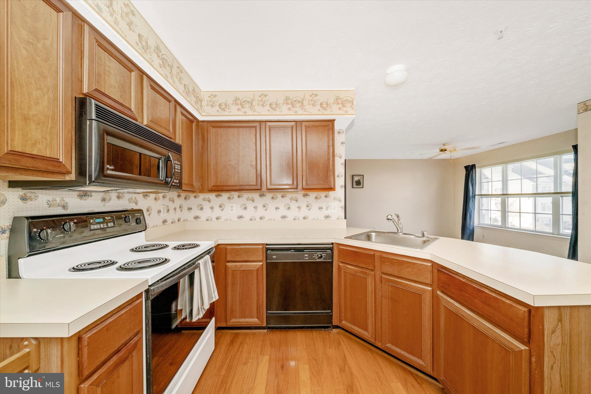 6117 Springwater Place, Unit 1723 Frederick, MD 21701 - Photo 23 of 50 a kitchen with a sink stove and cabinets