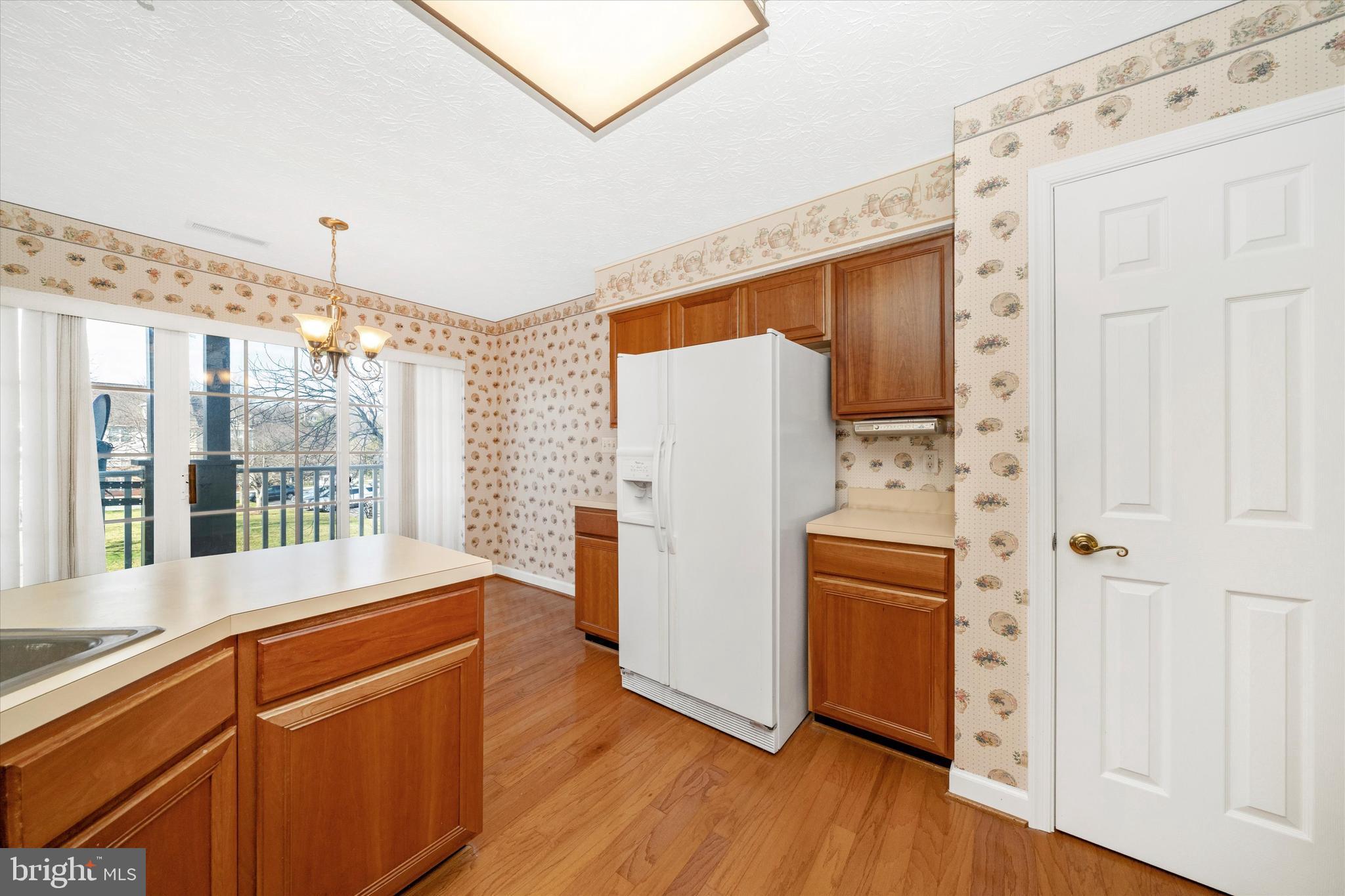 6117 Springwater Place, Unit 1723 Frederick, MD 21701 - Photo 24 of 50 a kitchen with stainless steel appliances a refrigerator and a stove