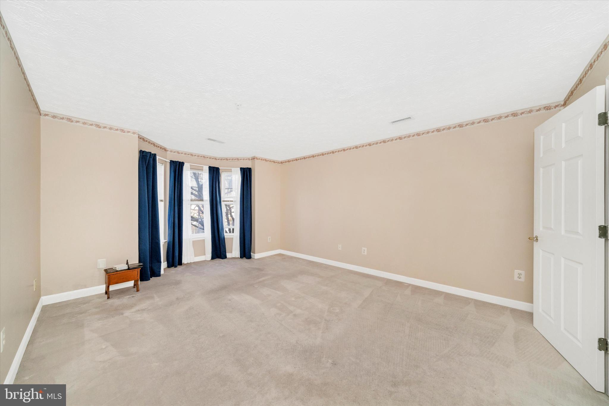 6117 Springwater Place, Unit 1723 Frederick, MD 21701 - Photo 26 of 50 an empty room with windows