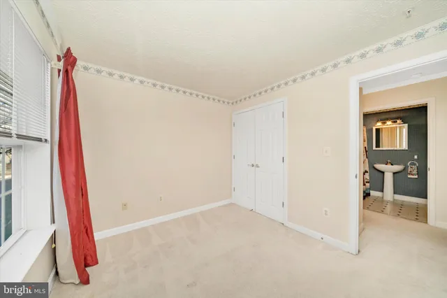 a view of a room with wooden floor and windows