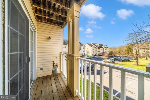 a view of a balcony with wooden floor and fence