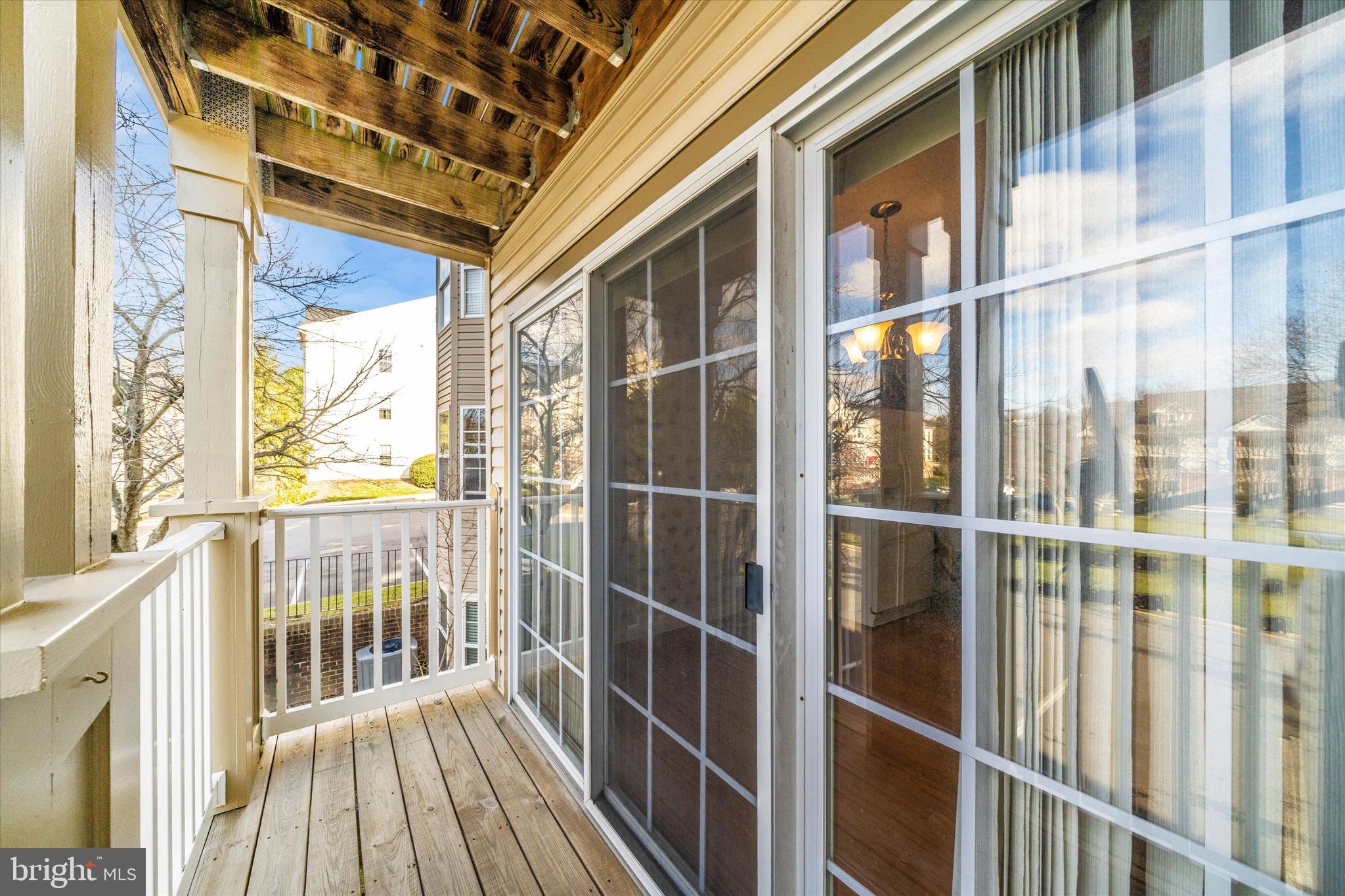 6117 Springwater Place, Unit 1723 Frederick, MD 21701 - Photo 39 of 50 a view of a balcony with wooden floor