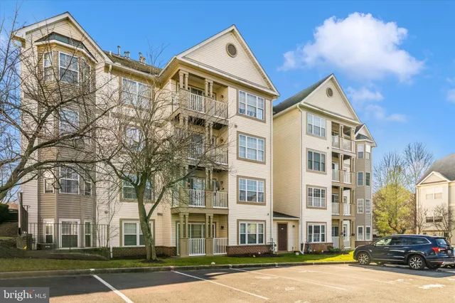 a front view of a residential apartment building with a yard