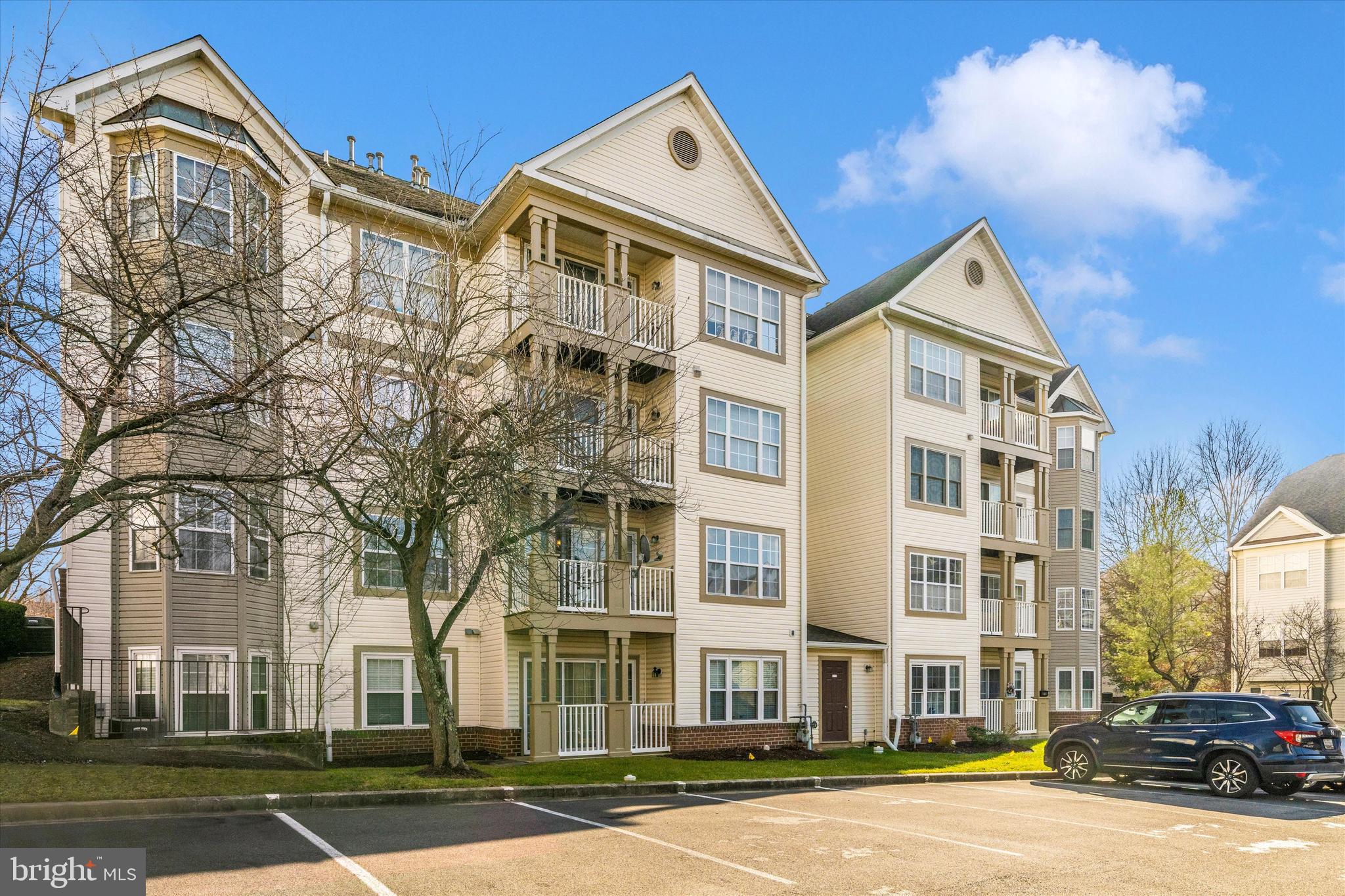6117 Springwater Place, Unit 1723 Frederick, MD 21701 - Photo 5 of 50 a front view of a residential apartment building with a yard