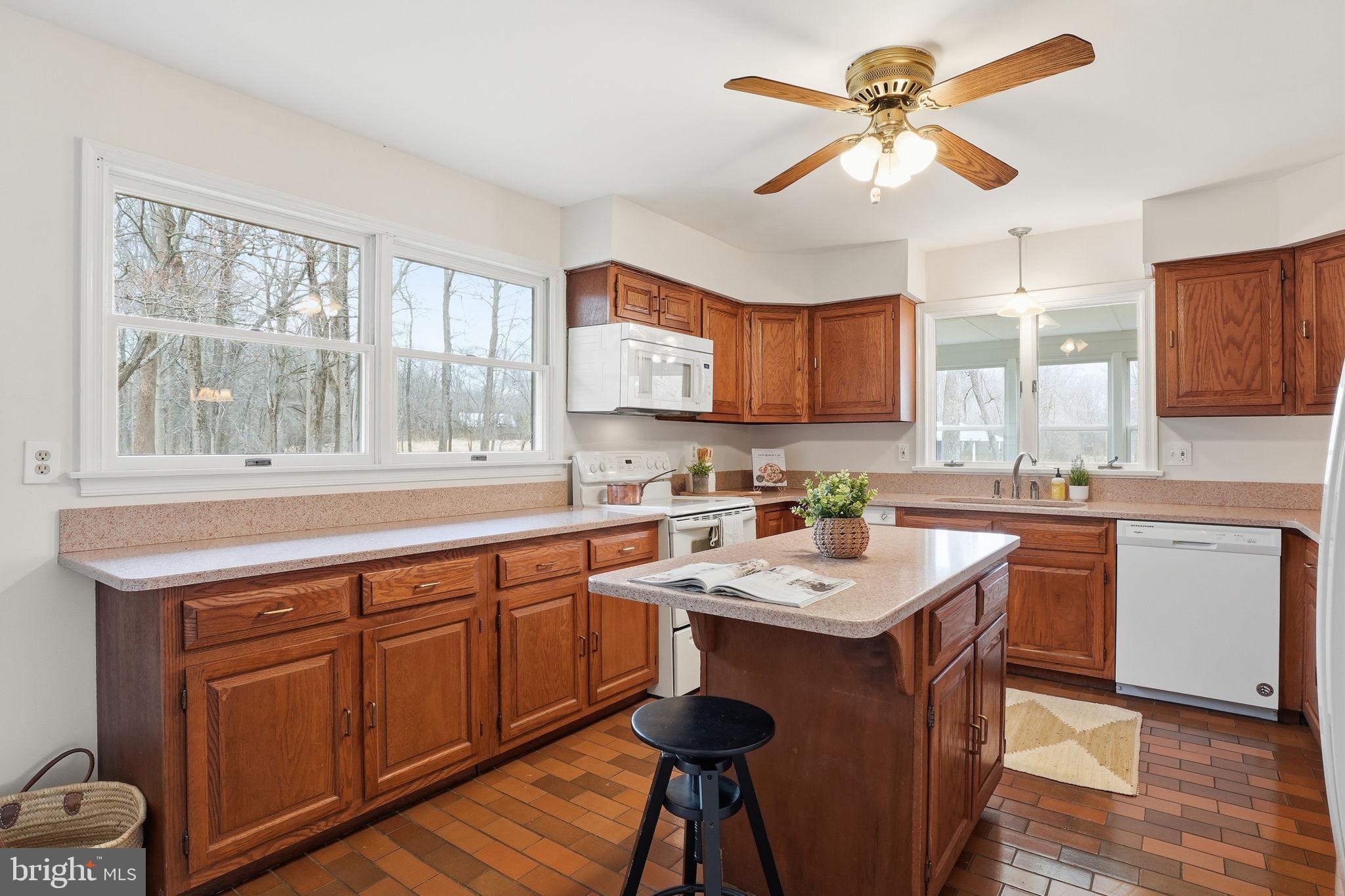 18311 Queen Anne Bridge Road Bowie, MD 20716 - Photo 17 of 46 a kitchen with a stove a sink a window and cabinets