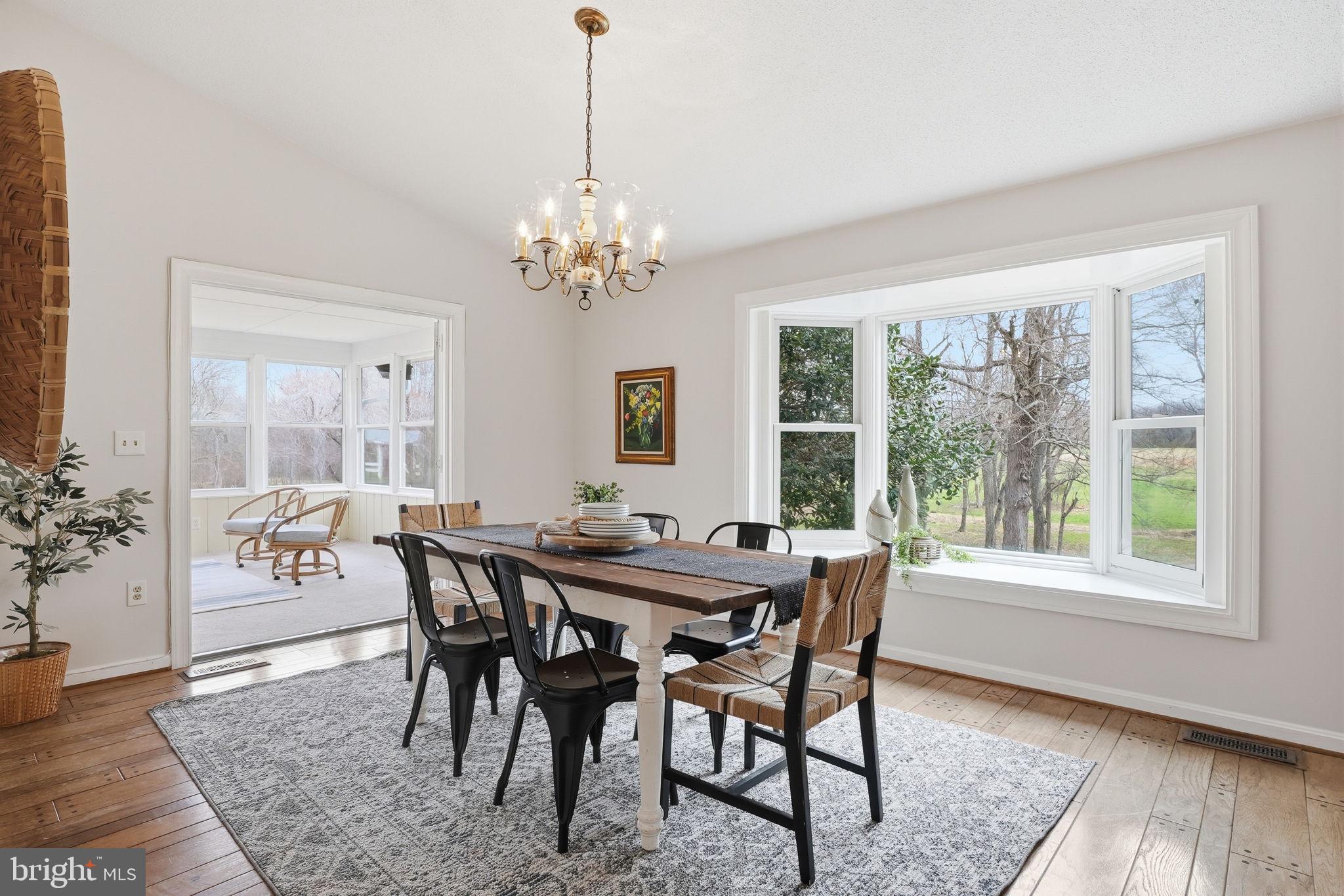 18311 Queen Anne Bridge Road Bowie, MD 20716 - Photo 23 of 46 a view of a dining room with furniture window and wooden floor