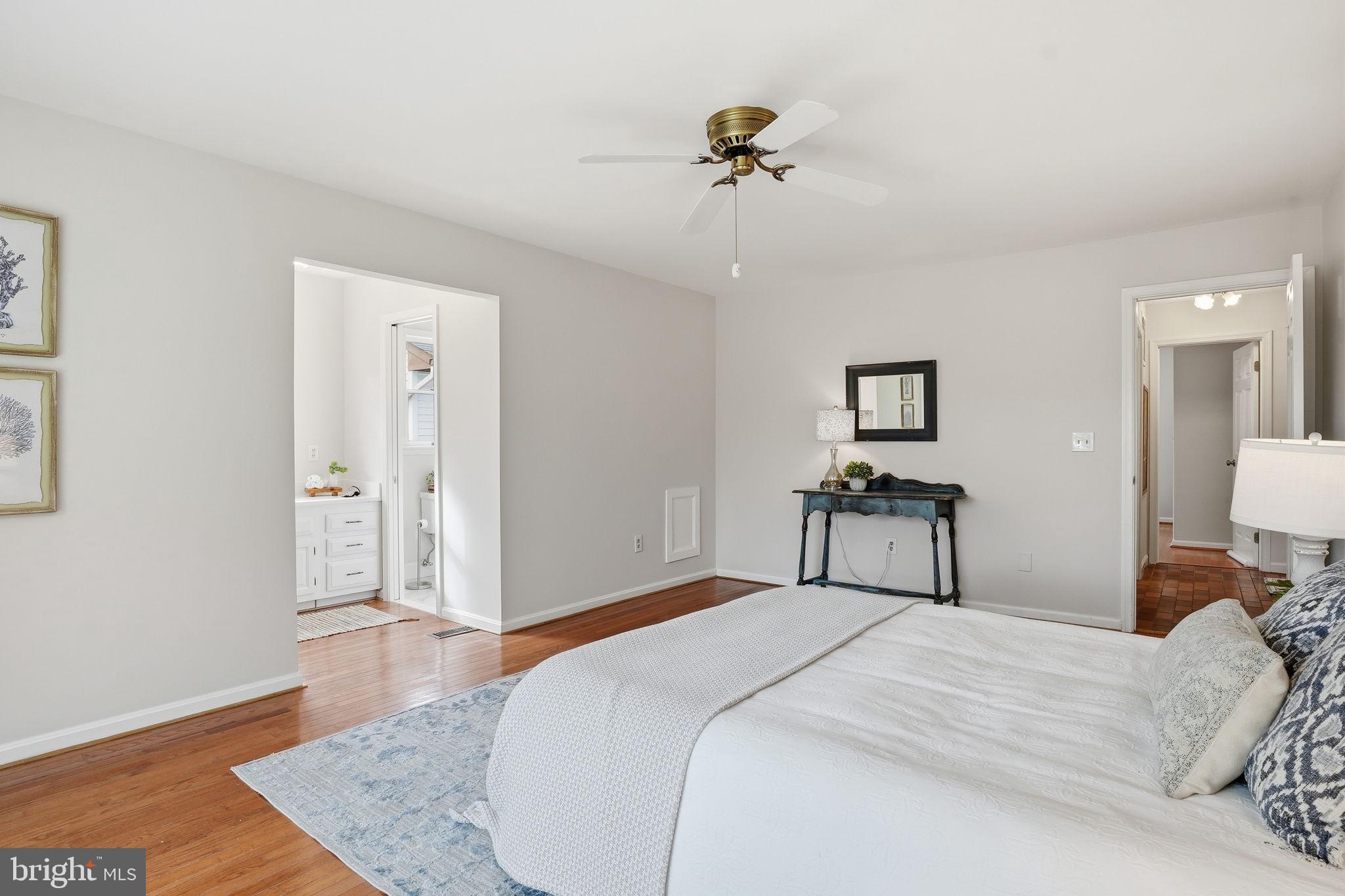 18311 Queen Anne Bridge Road Bowie, MD 20716 - Photo 26 of 46 a bedroom with a bed and a chandelier
