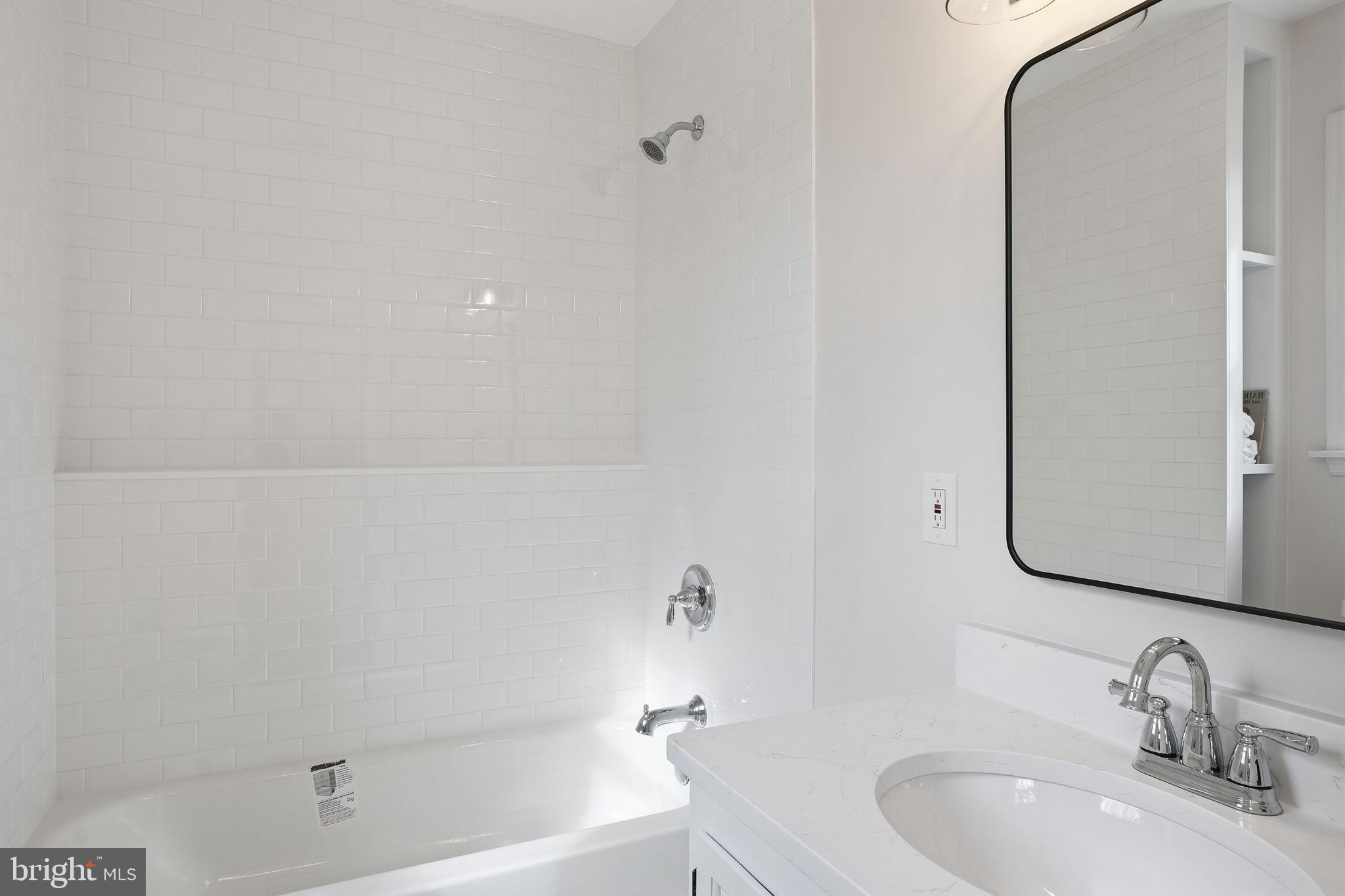 18311 Queen Anne Bridge Road Bowie, MD 20716 - Photo 27 of 46 a bathroom with a granite countertop sink and a mirror
