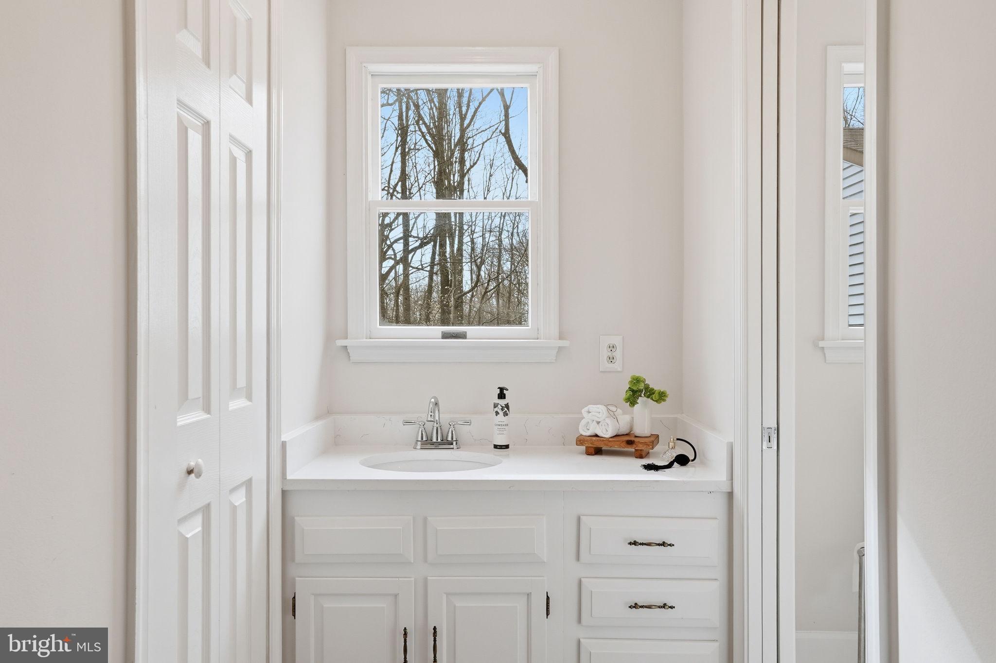 18311 Queen Anne Bridge Road Bowie, MD 20716 - Photo 28 of 46 a bathroom with a sink and a window