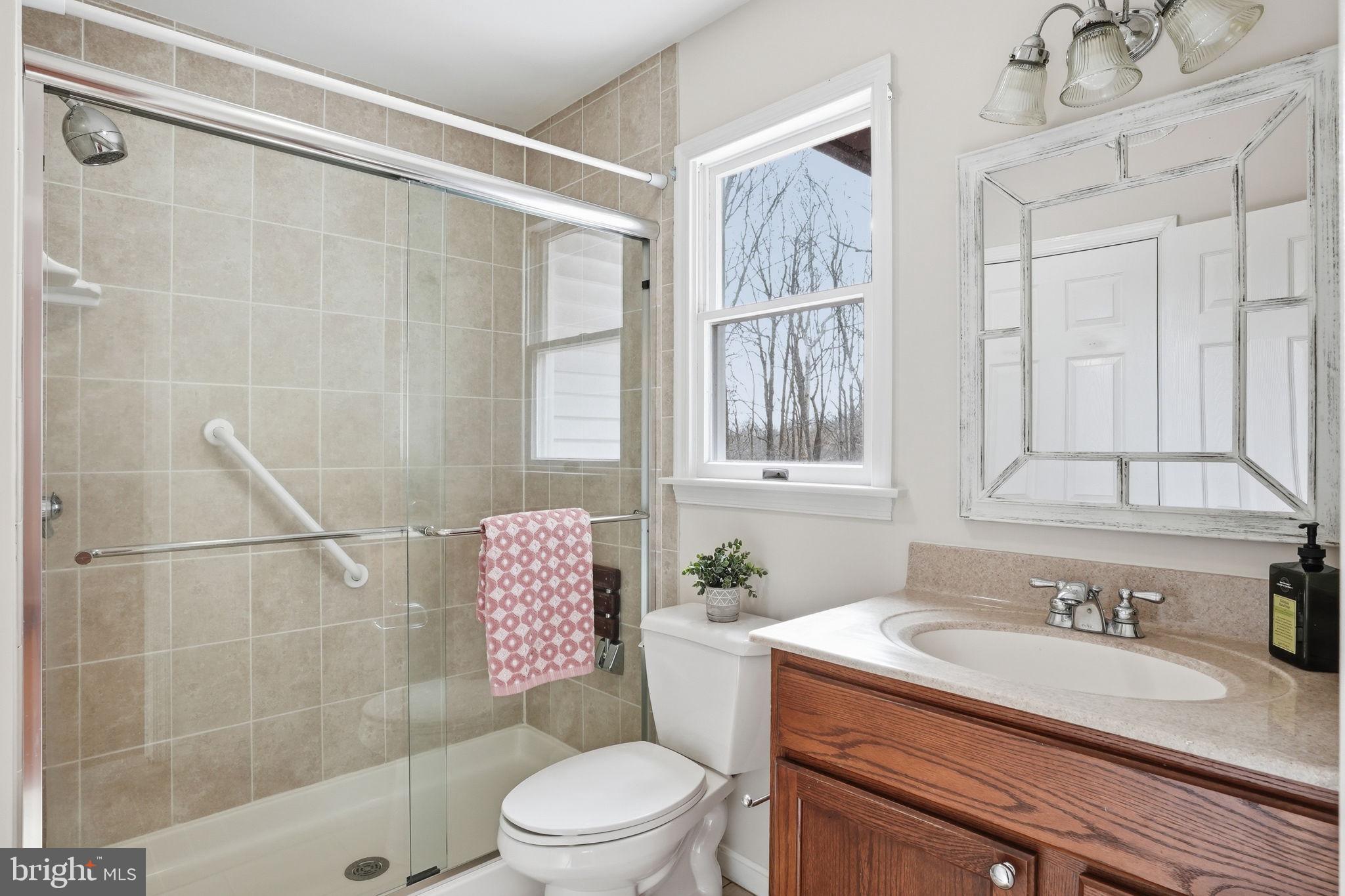 18311 Queen Anne Bridge Road Bowie, MD 20716 - Photo 31 of 46 a bathroom with a granite countertop sink toilet and shower