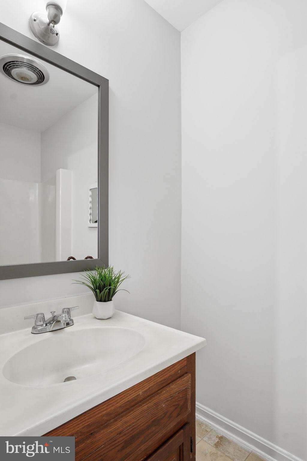 18311 Queen Anne Bridge Road Bowie, MD 20716 - Photo 35 of 46 a bathroom with a sink and a mirror
