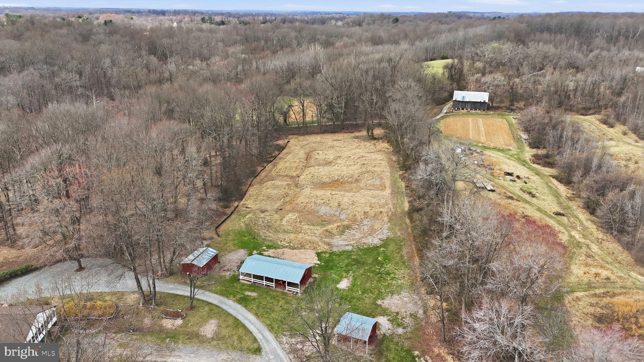 18311 Queen Anne Bridge Road Bowie, MD 20716 - Photo 4 of 46 an aerial view of a house with a yard and trees